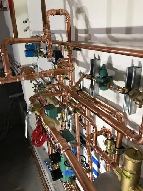 Complete copper hydronic system installation with circulators and manifolds — Guerra Bros. Plumbing